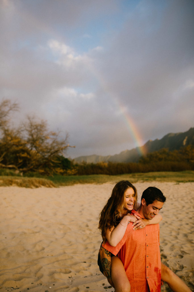 Couples session on the beach with a rainbow | 4 tips for how to rock your next couples session and family shoot, Mersadi Olson, Hawaii’s best wedding and engagement photographer. This blog post includes outfit tips and ideas, music suggestions, how to feel comfortable in front of the camera and how to pose for your photographer. Book your Hawaiii couples session, family session and wedding and browse the blog for inspiration #tips #photographytips #posingideas #fashion