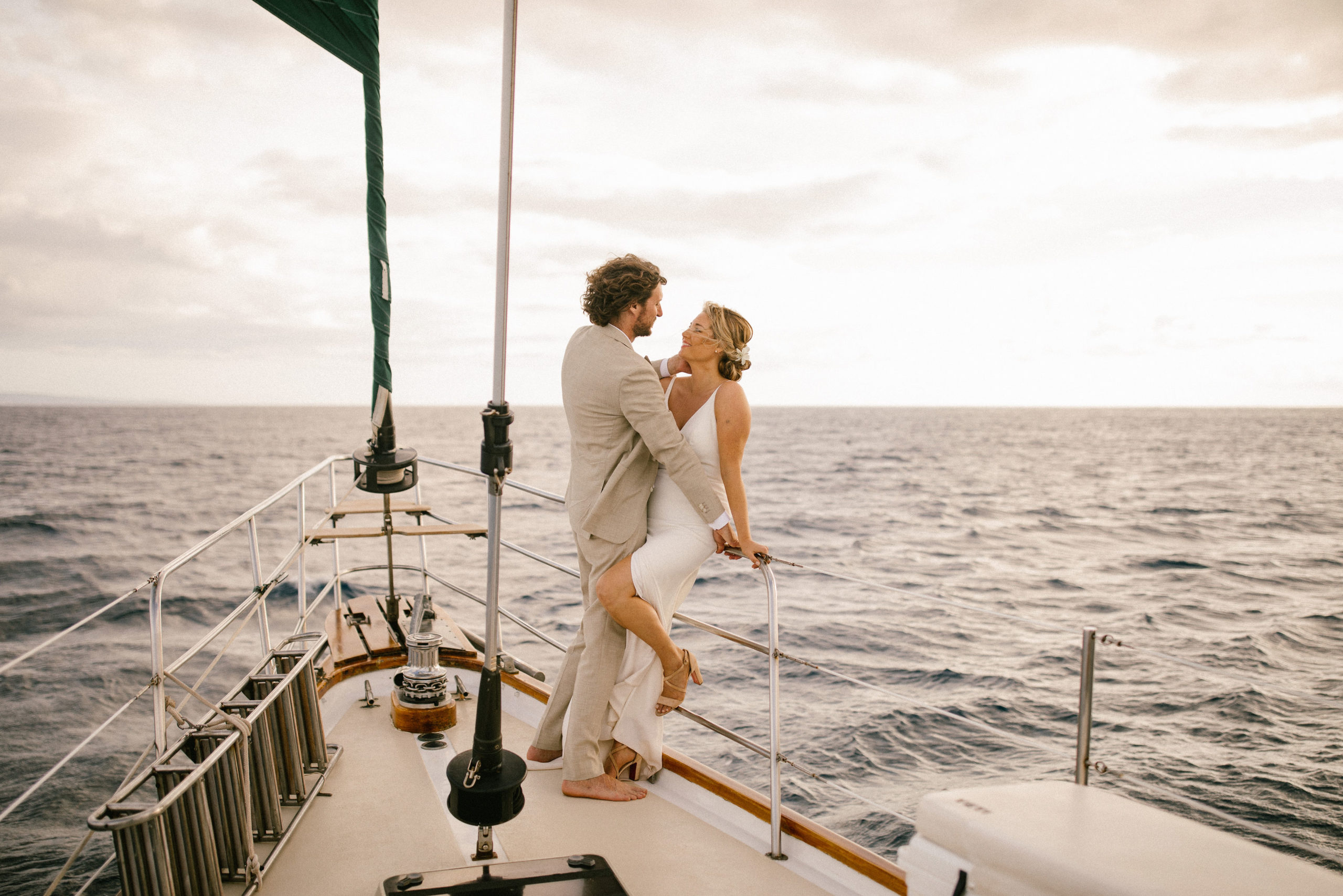 A couple on a sailboat on the ocean in Maui during their elopement on the Island
