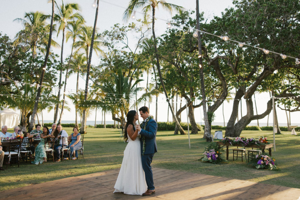 A married couple has their first dance during their wedding reception at Lanikūhonua on Oahu.