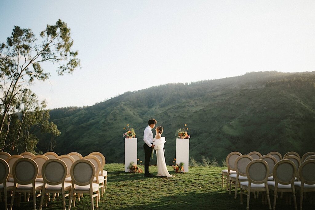 A bride and groom about to kiss in their ceremony space at Waialua Valley Farms