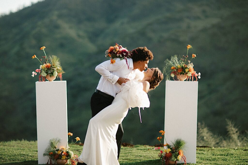 A bride and groom about to kiss at their wedding ceremony at Waialua Valley Farms.