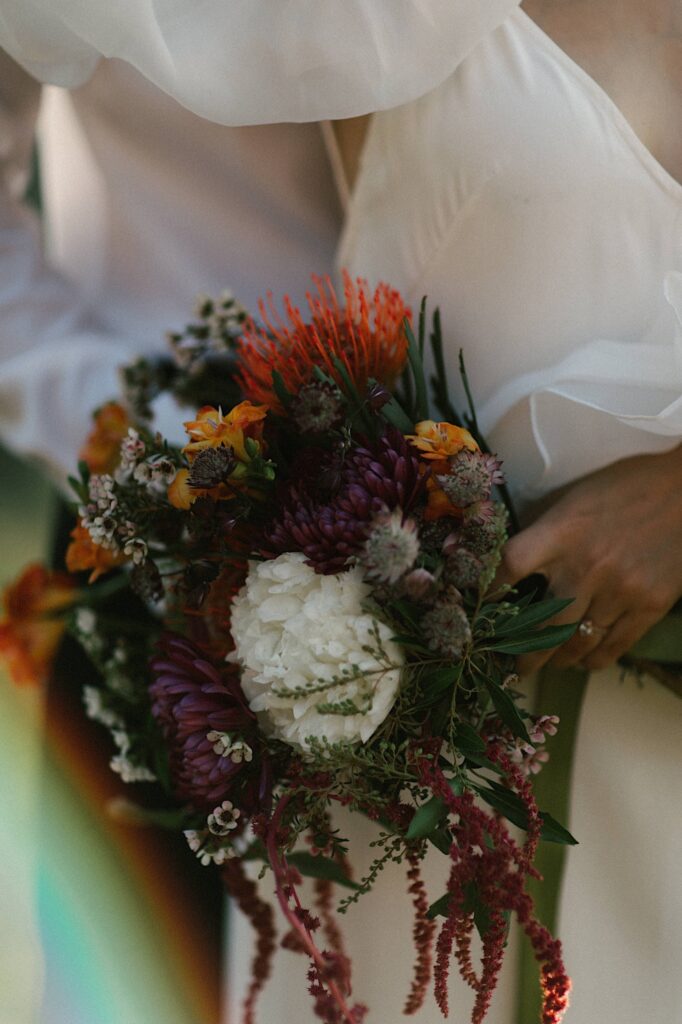 Close up of a wedding bouquet being held by a bride.