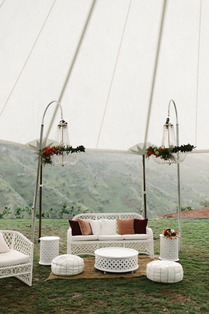 Lounge space that is set up for a wedding underneath a tent at Waialua Valley Farms.