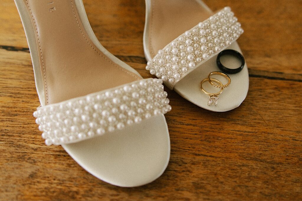 Detail photo of women's shoes, on the right shoe are 3 different rings