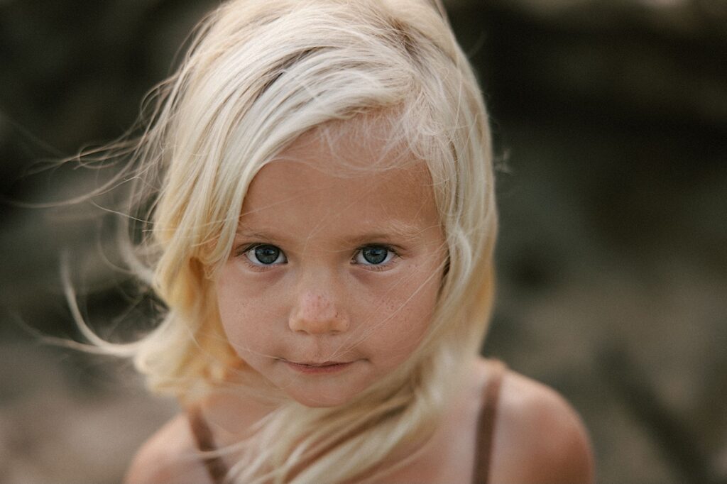 Portrait of young girl who's blond looking at the camera