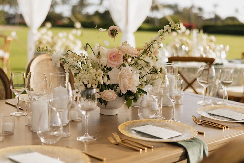 A table decorated for a wedding underneath a tent at Kukui’ula on Kauai
