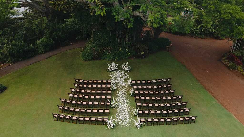 Aerial photo of the wedding ceremony space at the venue Kukui'ula decorated with while flowers