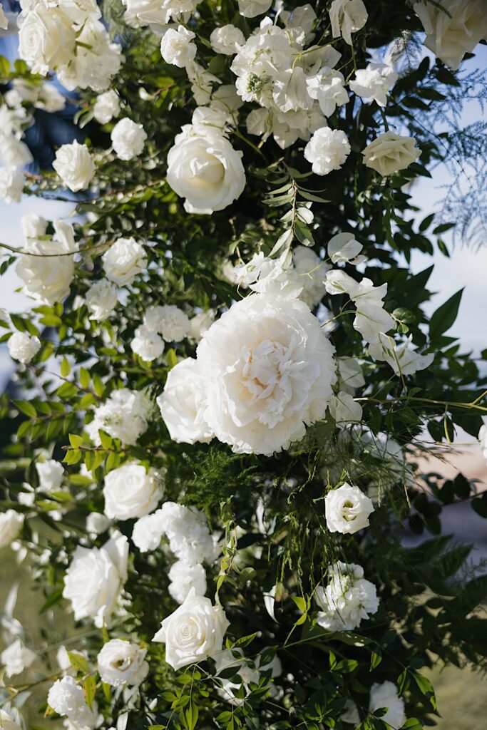 Detail photo of white flowers that are part of a wedding altar