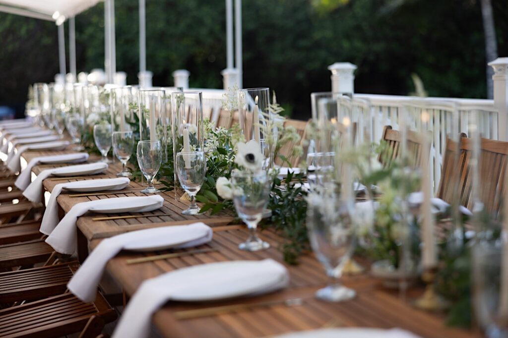 A long table is decorated and set up for the reception of an LGBTQ wedding at the venue Loulu Palm on Oahu