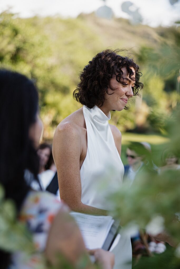 A bride smiles during her outdoor wedding ceremony at Loulu Palm