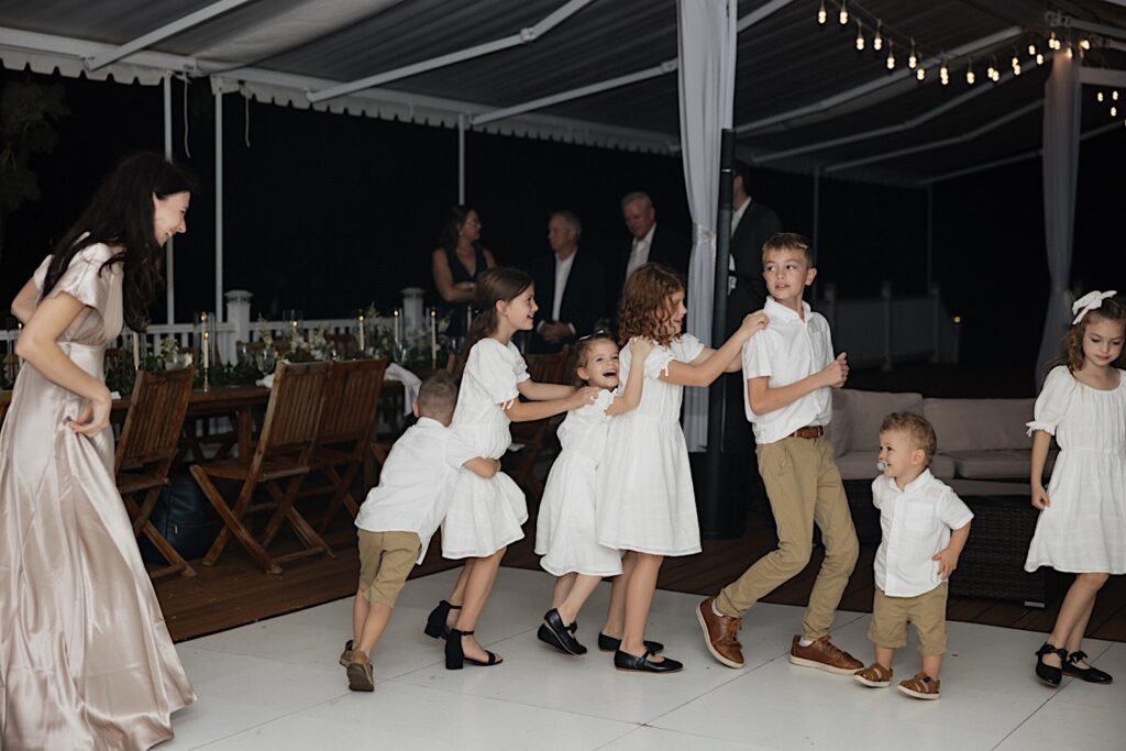 Children dance in a line during a wedding reception at Loulu Palm on Oahu