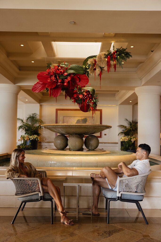 Jay and Mersadi of Olson Productions sit and chat next to an indoor water fountain at the Four Seasons Resort on Maui