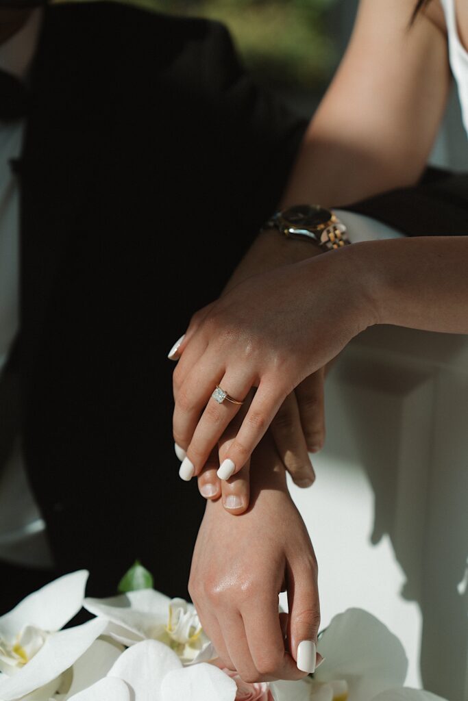 Hawaii Wedding Photographer captures Bride's hands holding her husbands surrounded by her beautiful tropical bouquet in Chapel at the Four Season Oahu in Hawaii. 