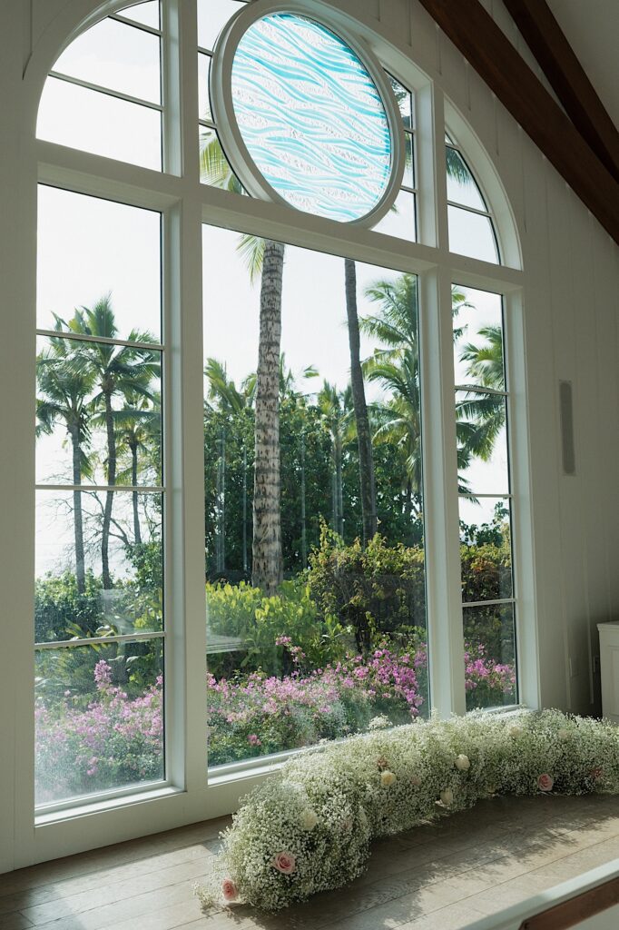 Four Seasons Oahu Chapel Window looks out onto beautiful Hawaii tropical trees and foliage. 