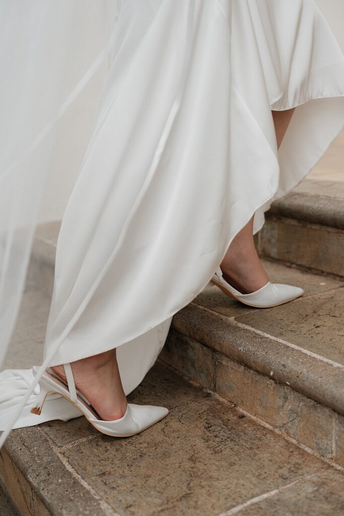 Hawaii wedding photographer captures bride's heels walking up the steps at Four Seasons Oahu in Hawaii. 