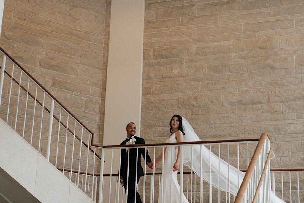 Bride and Groom walk up the steps to their reception at the Four Seasons Oahu in Hawaii.