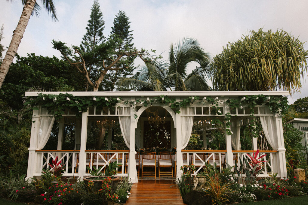 Hawaii wedding photographer captures a large gazebo holding a reception table for an intimate Hawaii wedding reception. 